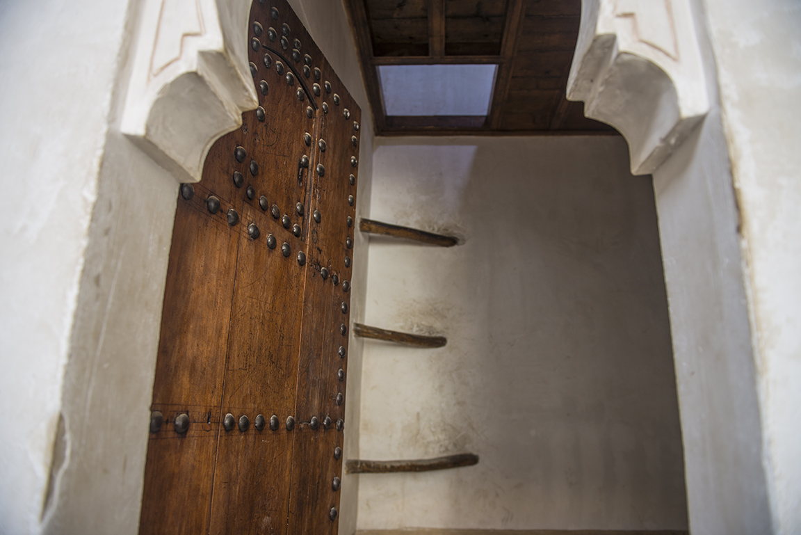 Ladder leading to upper level of dormitory room in the Ali ben Youssef Medersa