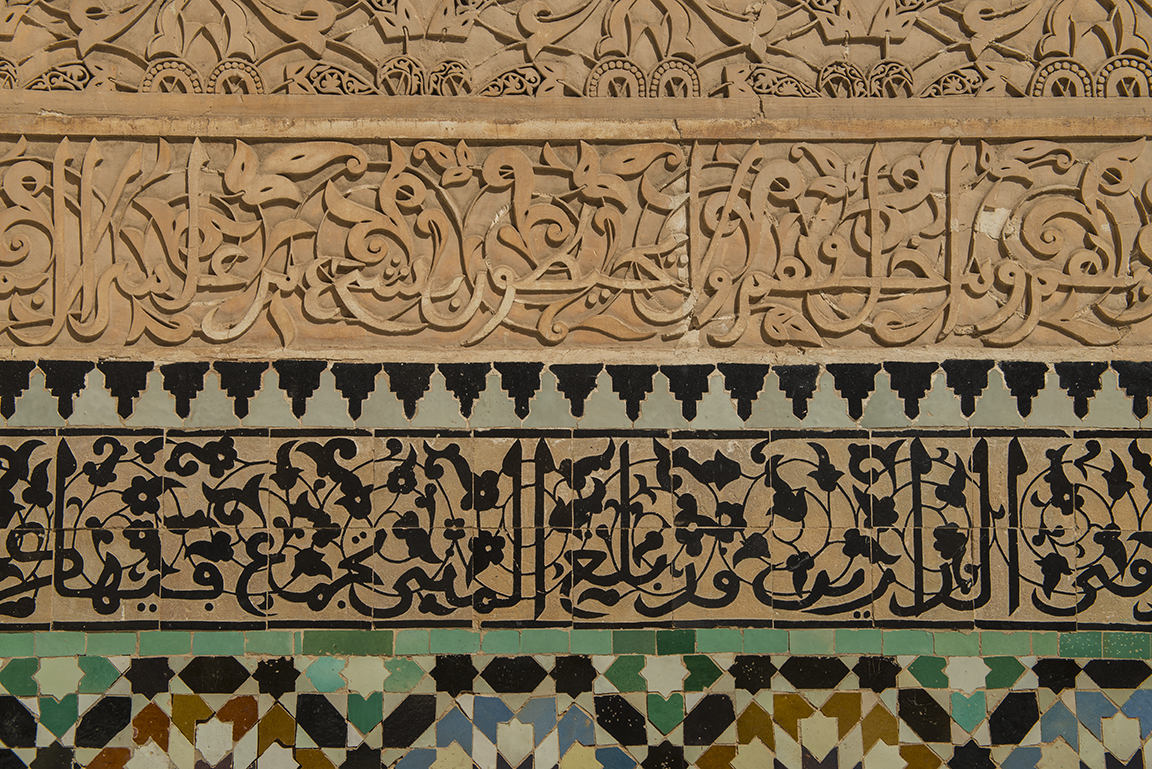 Islamic calligraphy and zellij tilework in the courtyard of the Ali ben Youssef Medersa